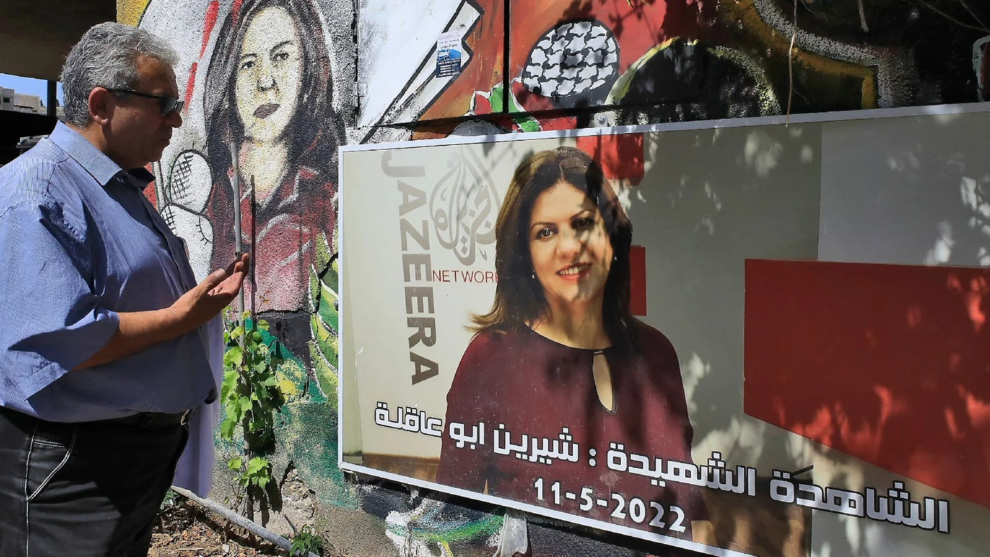 In this picture, taken on 11 May 2023, a man visits the spot where Al Jazeera journalist Shireen Abu Akleh was killed a year earlier while covering an Israeli raid (AFP)
