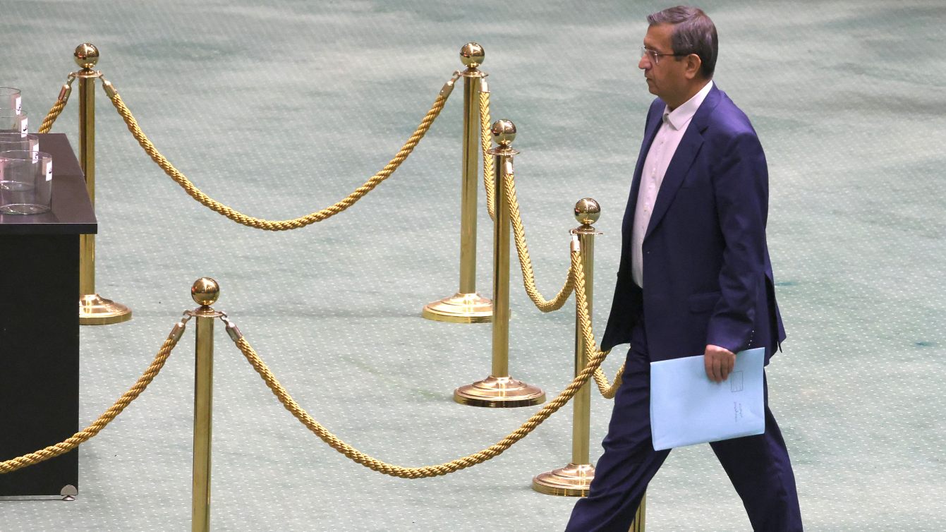 Iran’s Finance Minister Abdolnaser Hemmati walks to the podium during proceedings in parliament in Tehran, 2 March 2025 (Atta Kenare/AFP)