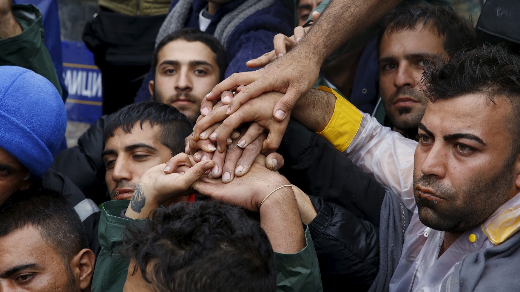 Iranian migrants sit on rail tracks during a hunger strike at the Greek-Macedonian border