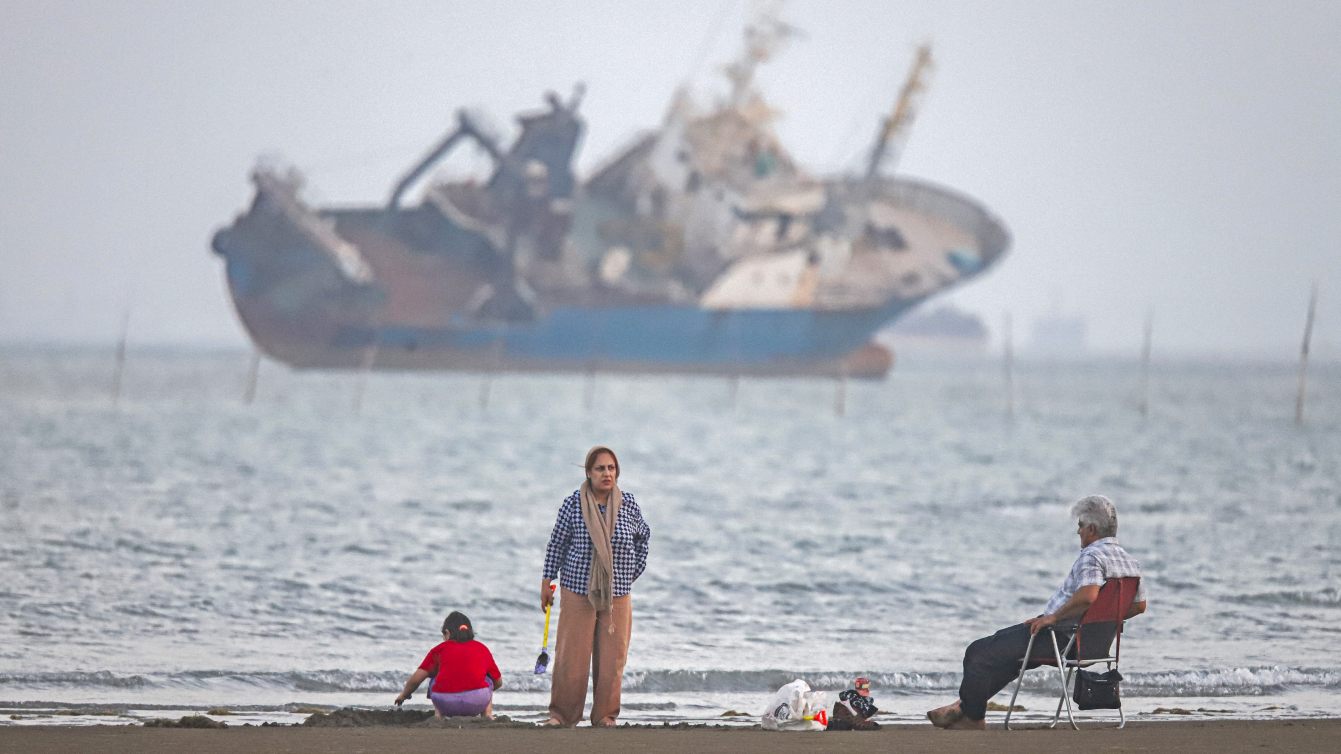 Iranians sit on Suru Beach in Bandar Abbas overlooking the Strait of Hormuz, 1 June 2026 (Amirhossein Khorgooei/ISNA/AFP) 