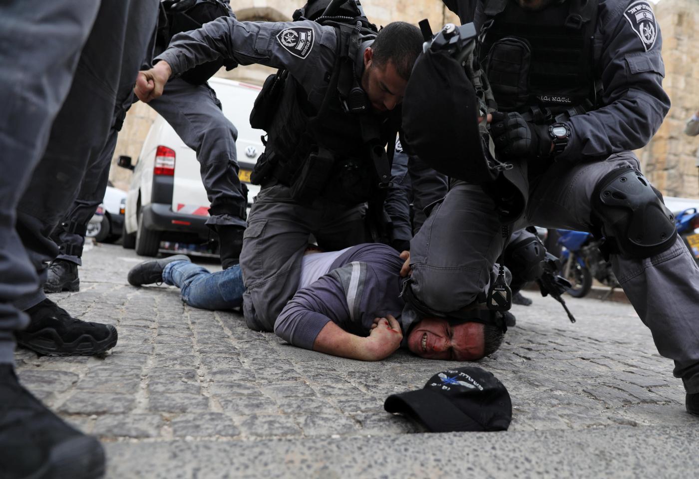 In the days following George Floyd's killing, pictures of Israeli authorities taking similar positions over the necks of Palestinians have begun appearing across social media (Reuters)
