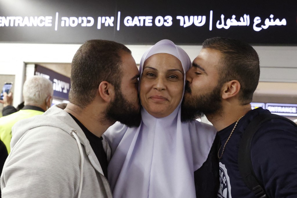 Relatives greet Israelis evacuated from Ukraine at Ben Gurion airport, Tel Aviv on 1 March 2022 (AFP)