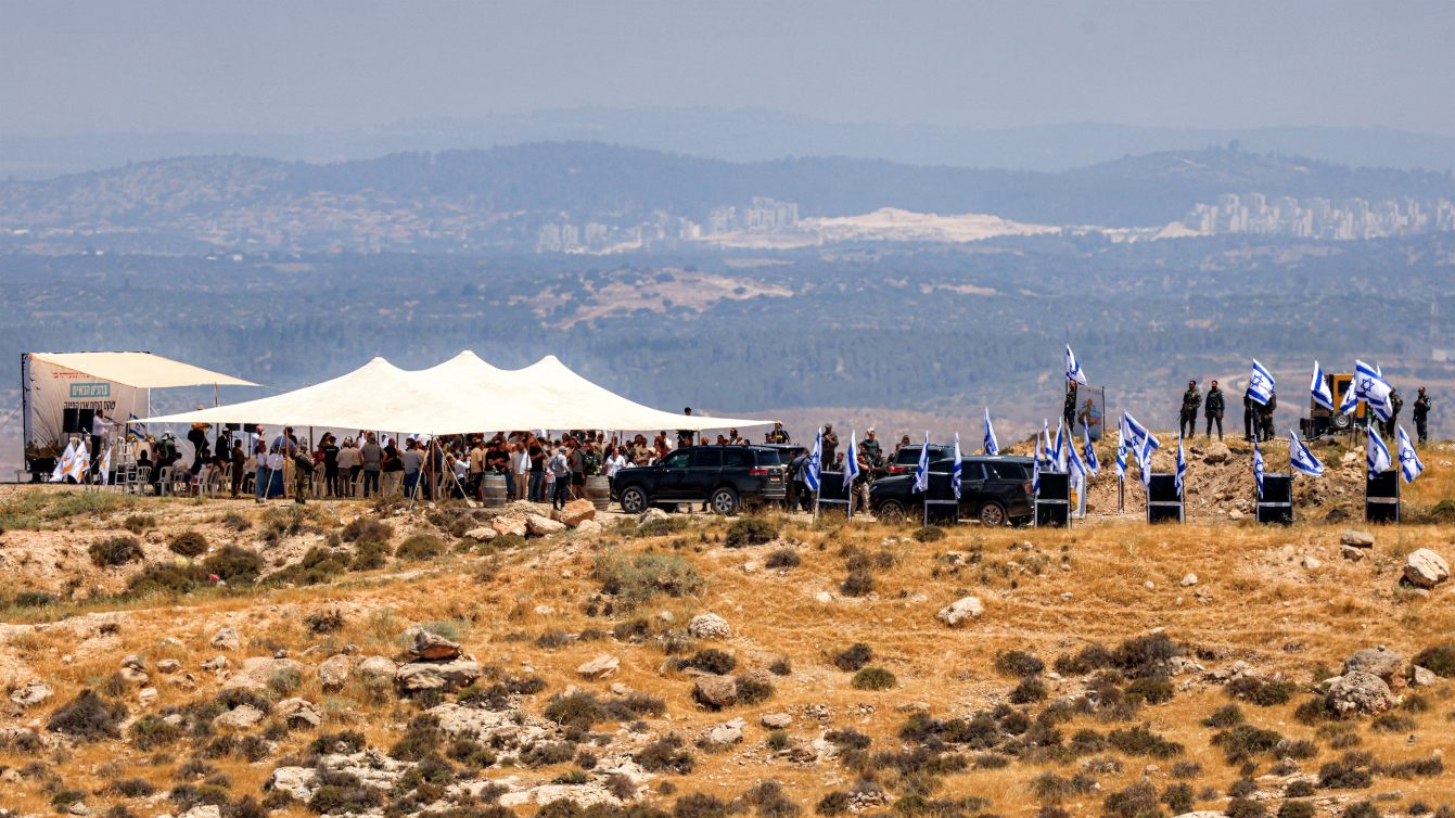 Israeli settlers, accompanied by Finance Minister Bezalel Smotrich, attend a cornerstone-laying ceremony for a new settlement near Hebron in the occupied West Bank, 16 June 2026 (Hazem Bader/AFP)