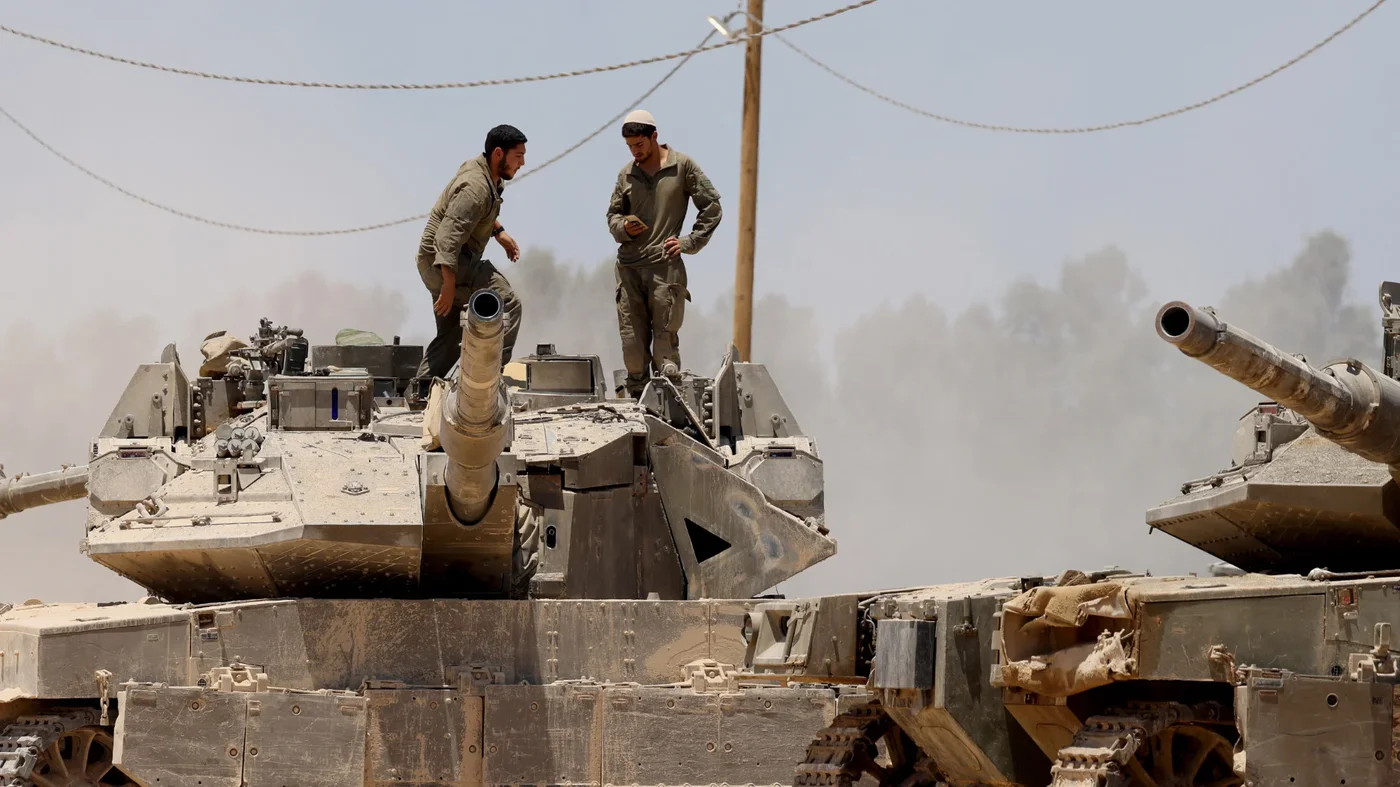 Israeli troops deploy by Israel's boundary with the Gaza Strip on 15 July (Jack Guez/AFP)