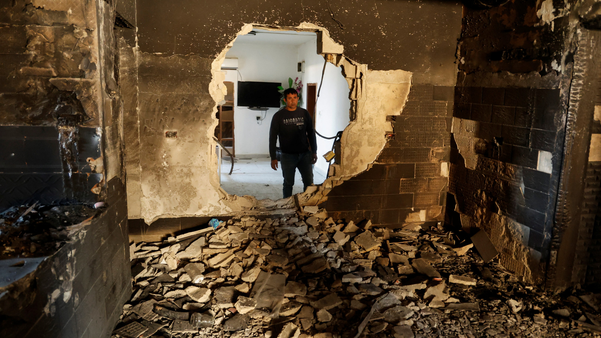 A man views a house destroyed during violent raids carried out by Palestinian Authority security forces in Jenin refugee camp in the Israeli-occupied West Bank, on 8 January 2025 (Raneen Sawafta/Reuters)