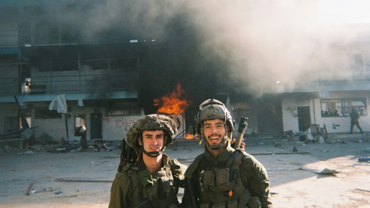 Jonathan Burman and another soldier stand in front of the Madrasa al-Farabi in Gaza. (Obtained by Declassified UK) 