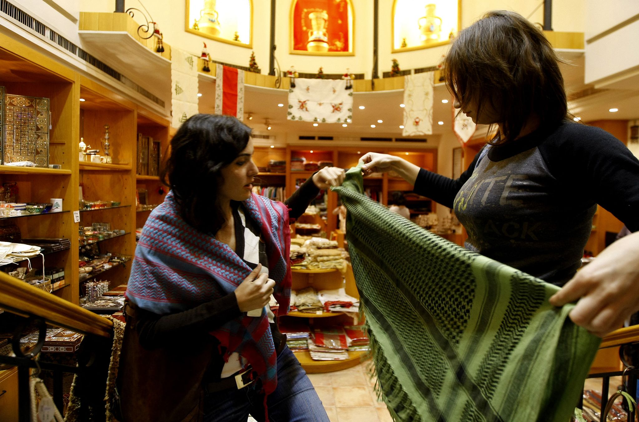 Fashion trends saw the keffiyeh move away from the traditional colour and fabric, with mass produced versions flooding the market in the 2000s (Joseph Barrak/AFP)