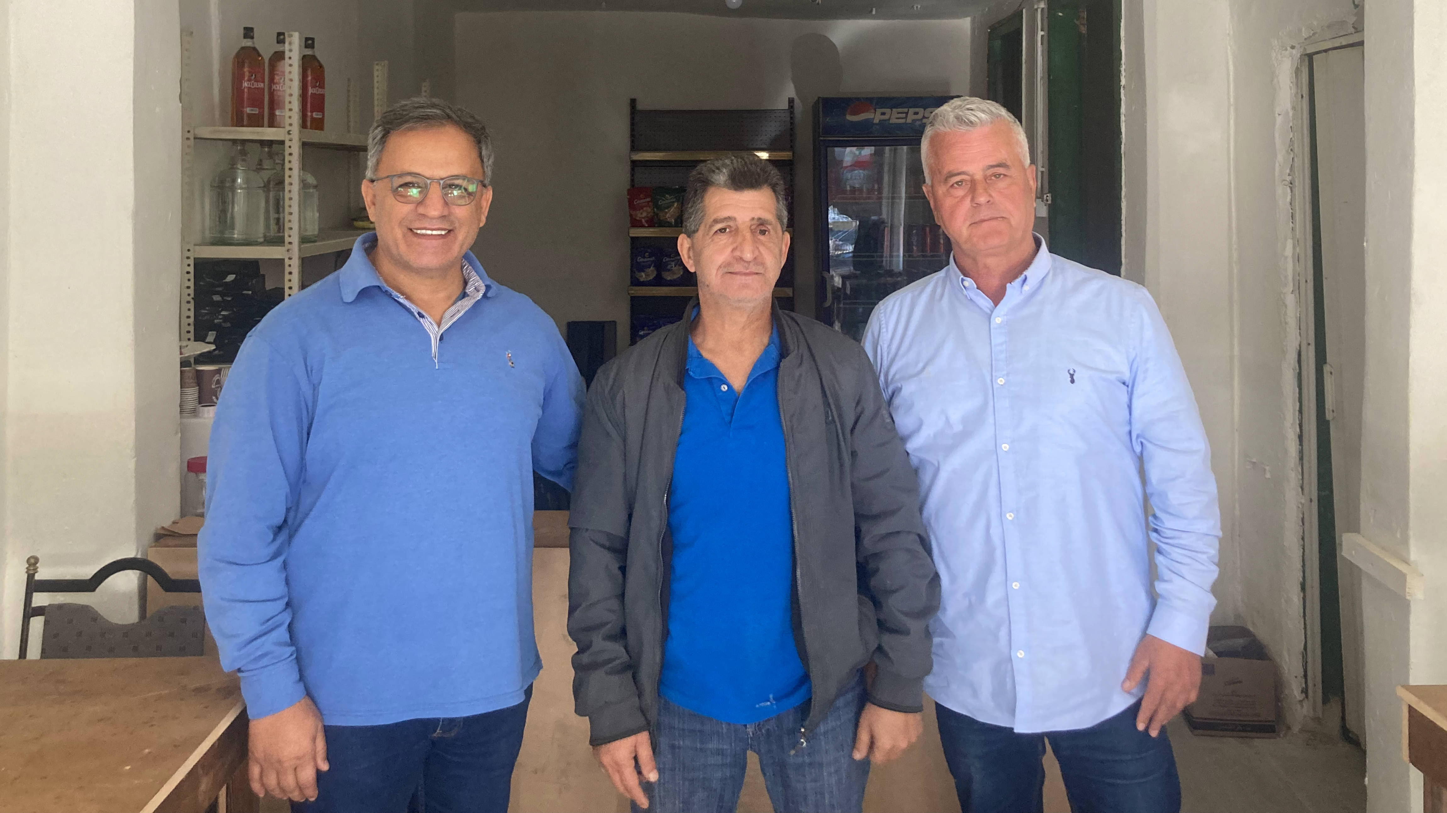General Joseph el-Asmar, (R) and General Georges Nader (L) pose with fellow army veteran inside the Soldier's House (Chloe Domat/MEE)