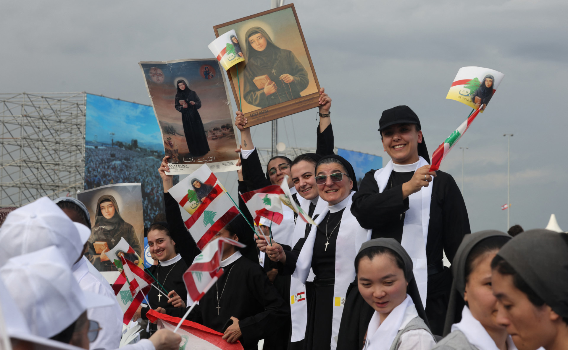 Faithful cheer as Pope Leo XIV arrives for a mass at the waterfront in Beirut on 2 December 2025 (AFP)