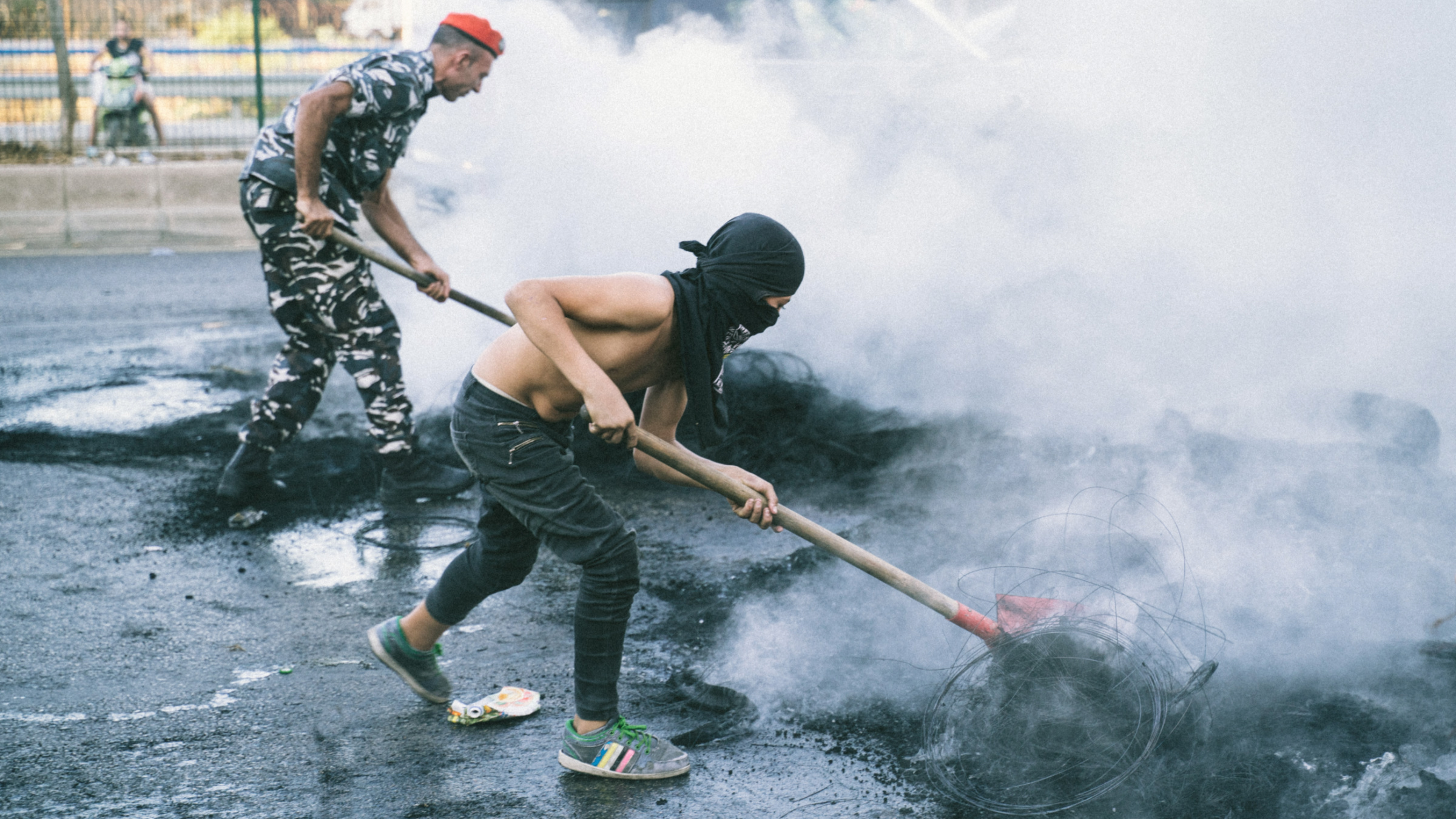 Lebanese security forces reopen a road that was blocked by protesters after the government announced an increase in fuel prices in October 2021 (MEE/Clément Gibon)