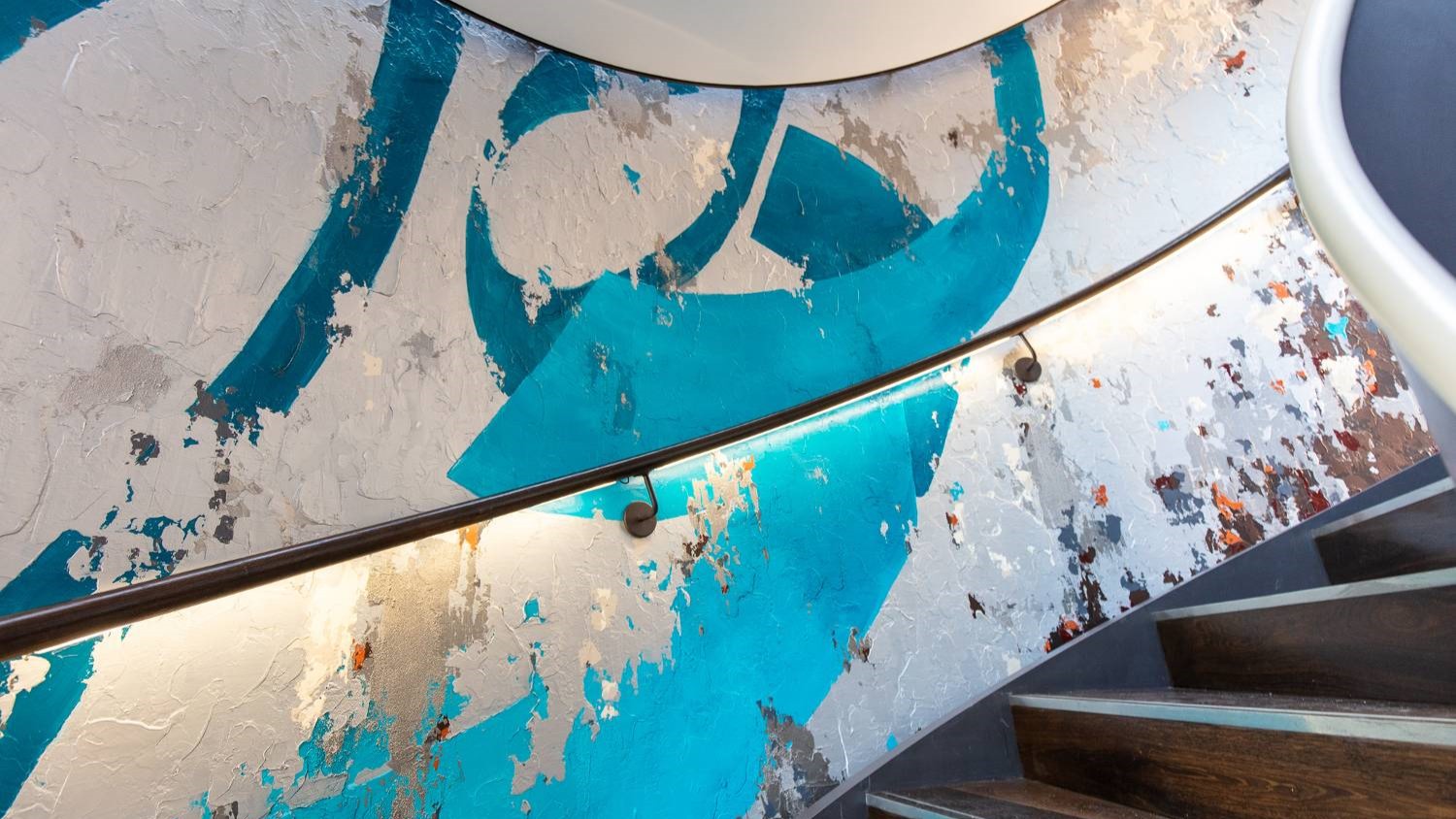 Oneness, inspired by a Rumi poem, encircles the curved walls of a new helical staircase across three floors (Zirrar Ali)