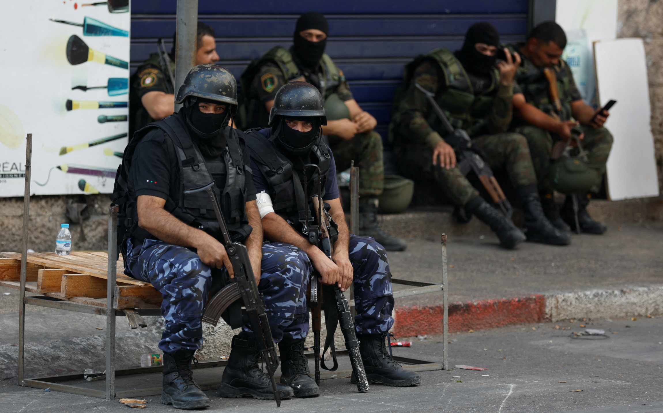 Palestinian security forces keep guard following clashes with gunmen over the arrest of two Palestinian fighters in Nablus on 20 September 2022 (Reuters)