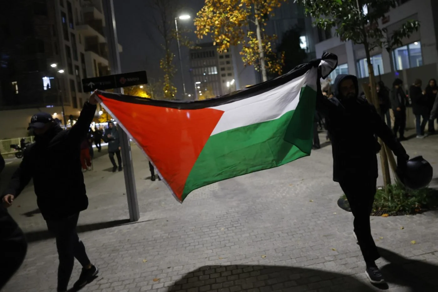 Protesters with a Palestinian flag after a demonstration against the holding of the Uefa Nations League match between France and Israel, in Aubervilliers, in the northern outskirts of Paris, on 14 November 2024 (Ian Langsdon/AFP)