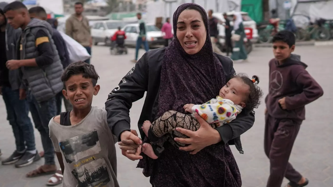 palestinians react after bombardment al-bureij camp