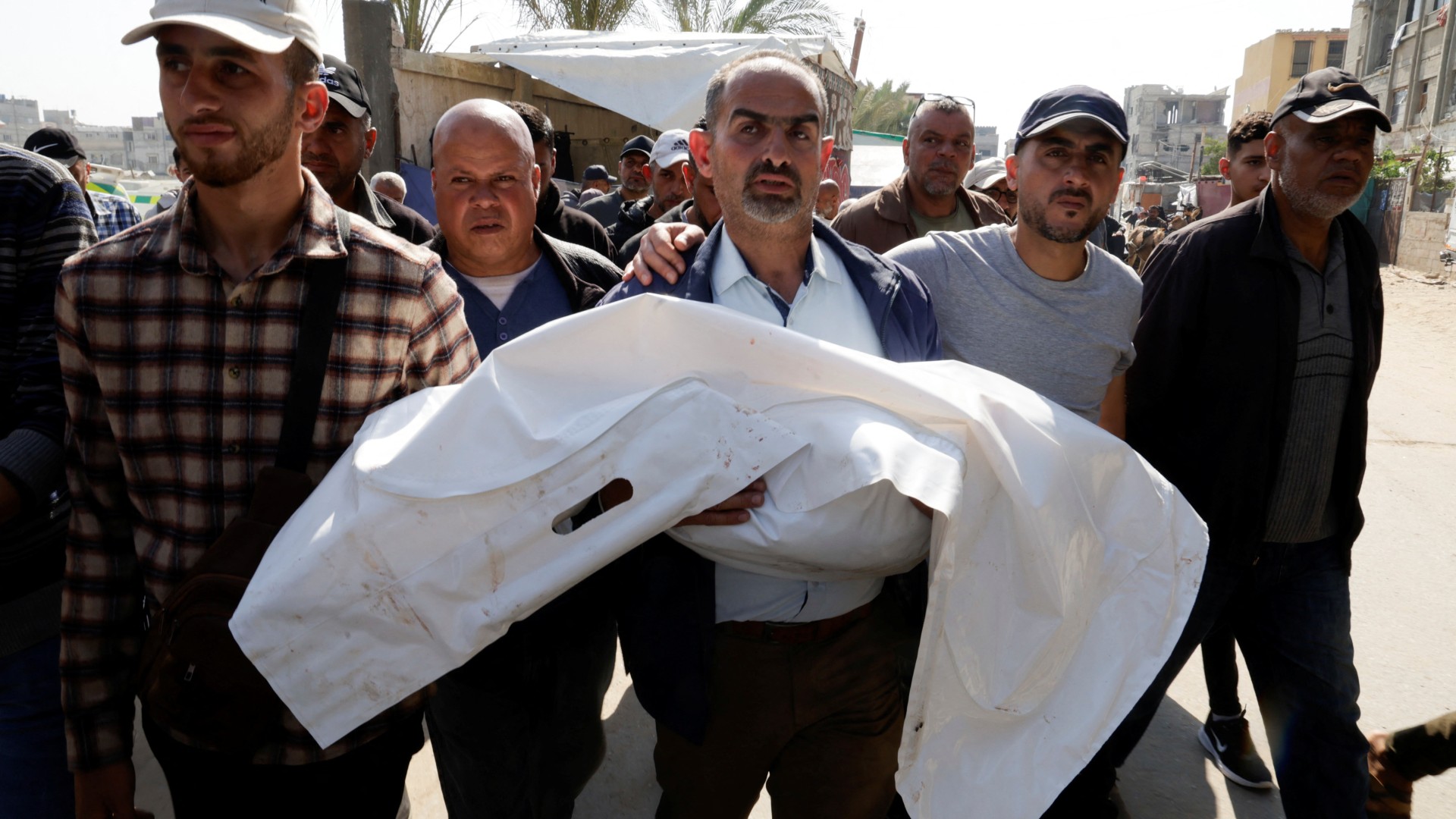Palestinians in Khan Younis carrying their dead loved ones after an Israeli strike killled them (Reuters/Hatem Khaled)