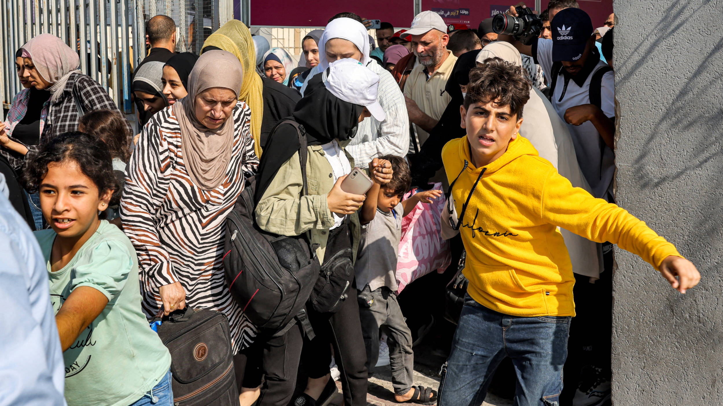 eople walk through a gate to enter the Rafah border crossing to Egypt in the southern Gaza Strip on 1 November 2023 (AFP)