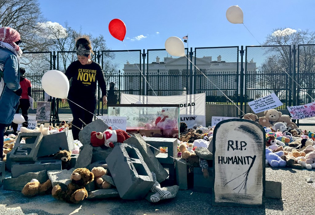 Plush toys for young Palestinian victims in the Israel-Hamas conflict are placed in front of the White House as protesters rally during the 