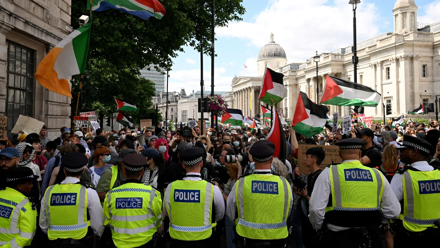 Police officers block a street at a protest against Britain's plan to proscribe the Palestine Action group, in London, 23 June 2025 (Reuters)