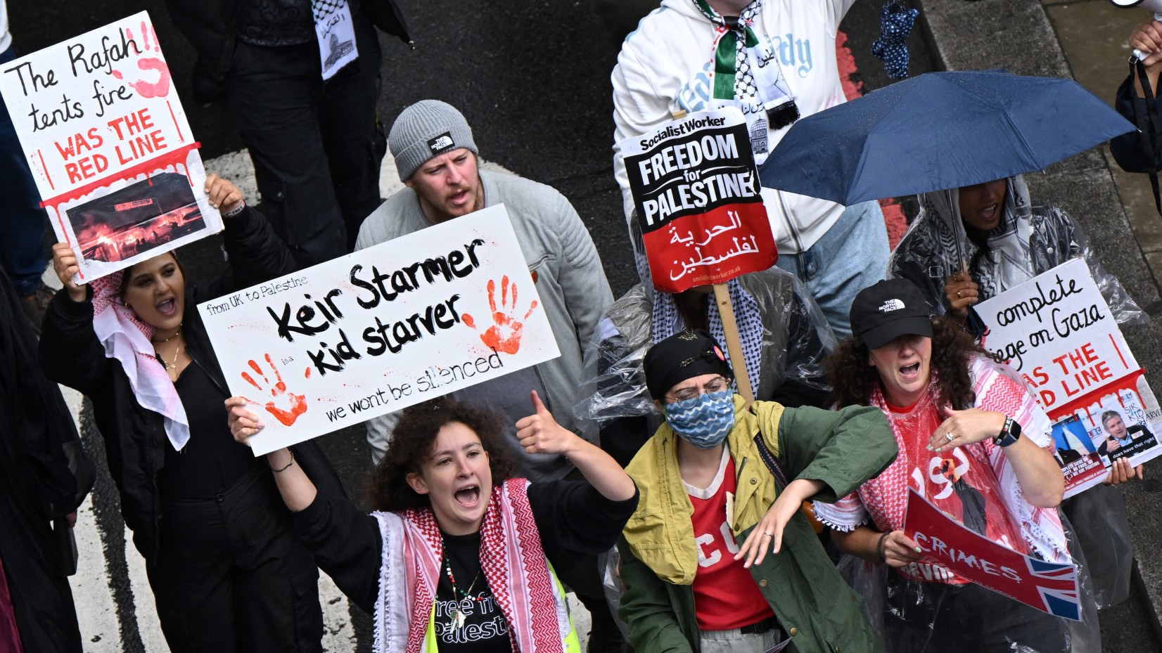 Pro-Palestinian protesters holding placards against Britain's new Prime Minister Keir Starmer shout slogans as they march during the 
