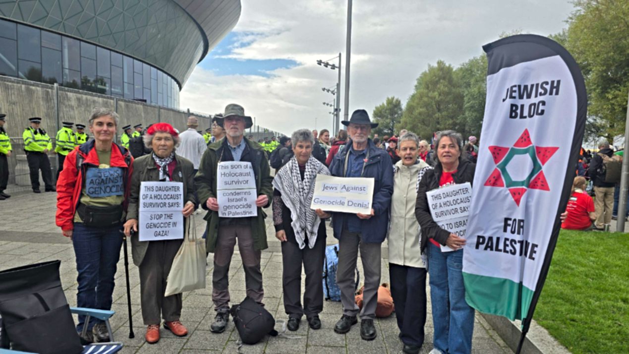 Protesters pose for a photo as they prepare to be arrested during a protest against the Palestine Action ban in Liverpool, 27 September 2026 (Imran Mulla/Middle East Eye)