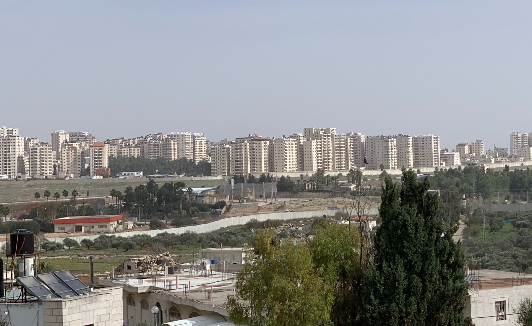 The airport is no longer accessible to residents of Qalandiya. The building with the orange roof on the left is now an Israeli military factory (MEE/Shatha Hammad)