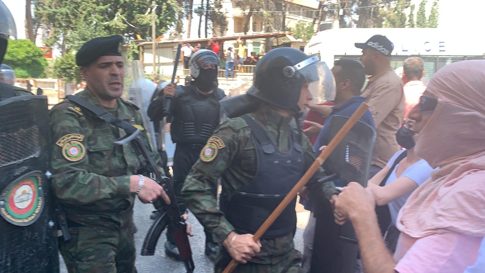 A member of Palestinian Authority forces wields a baton during the demonstration in memory of Nizar Banat in Ramallah on 24 June 2021 (MEE/Shatha Hammad)