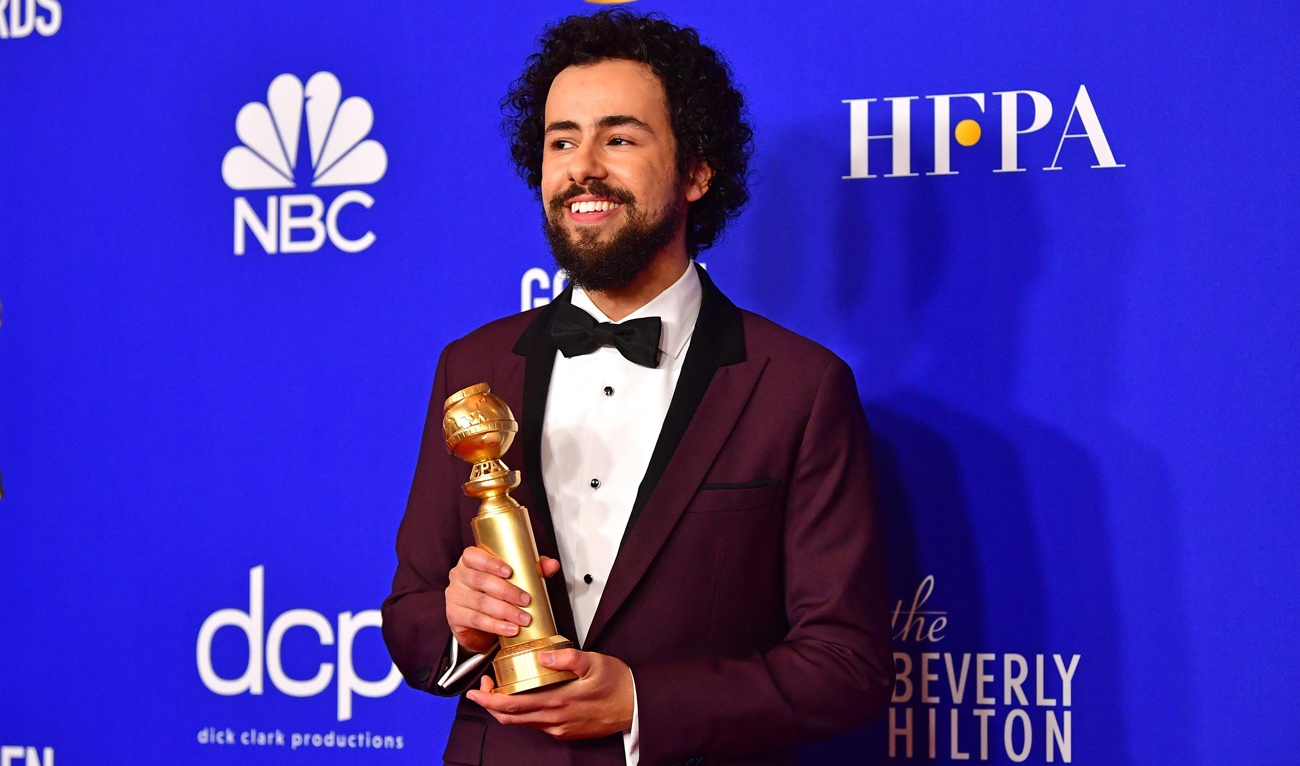 Ramy Youssef collects his Golden Globe for Best Actor (Musical or Comedy) in January 2020 (AFP)