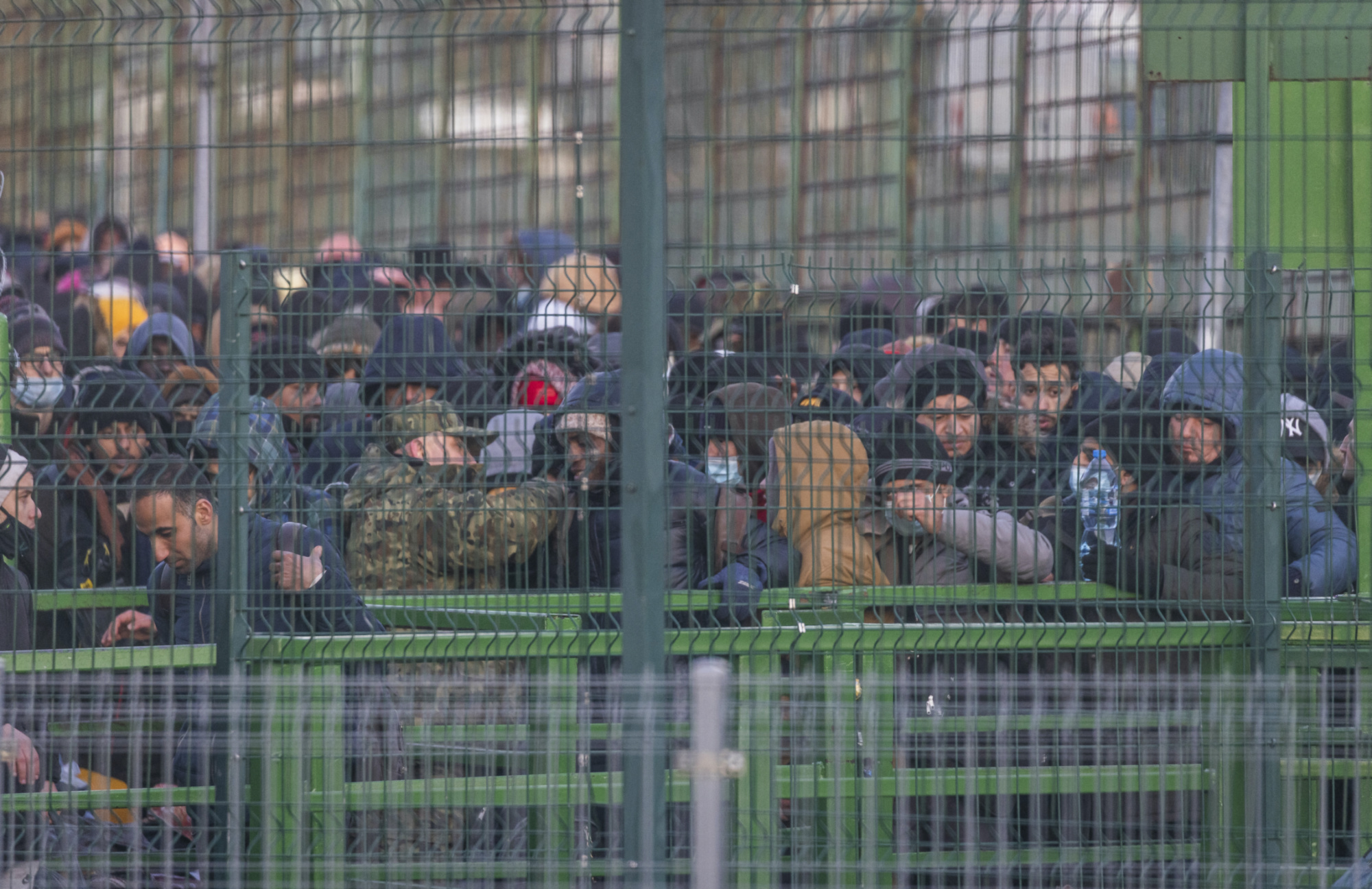 Refugees from Ukraine line up to get in to Poland 