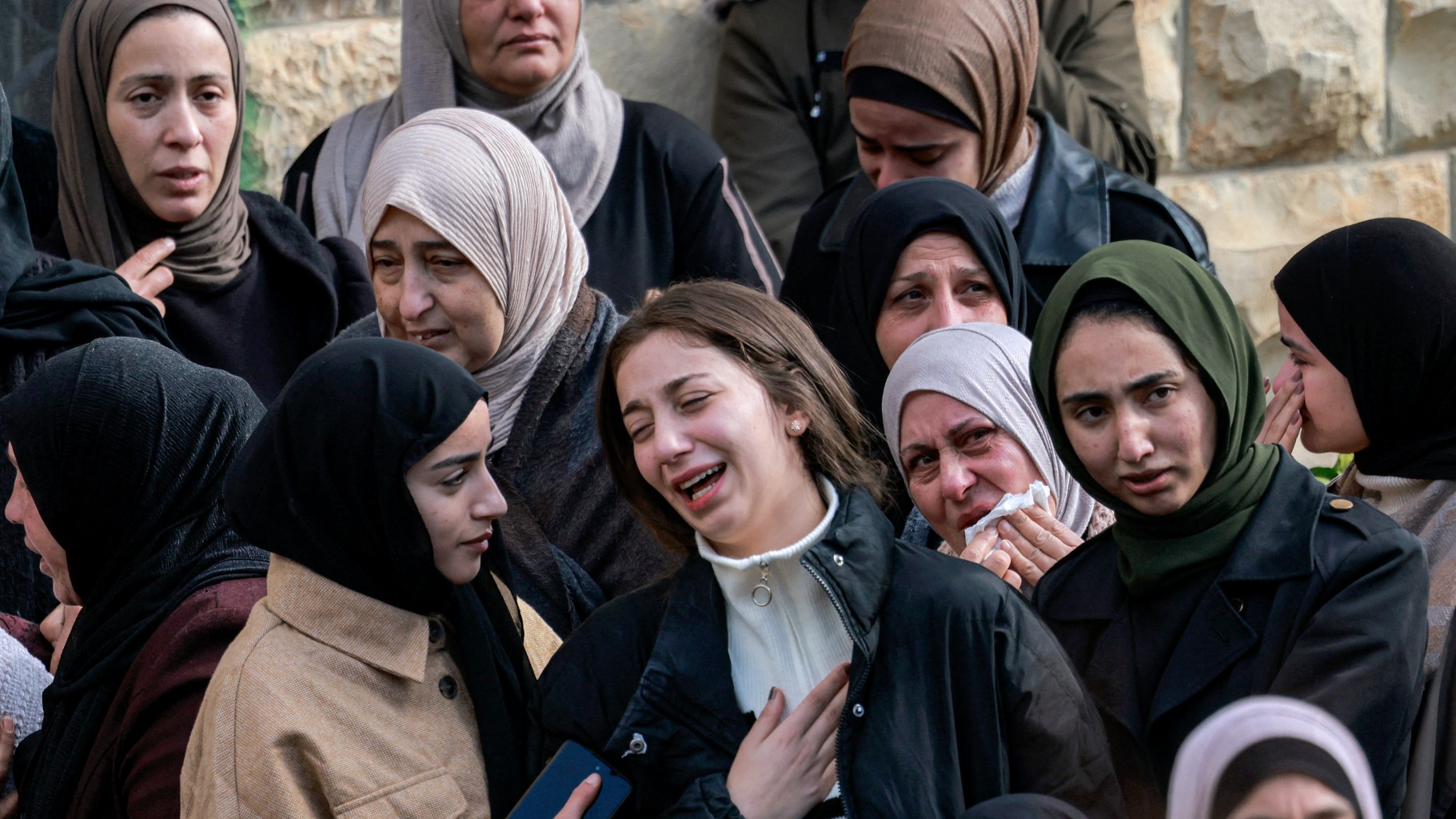 Relatives of Palestinian teenager Ahmad Rushdi, who was killed by the Israeli military in the village of Sebastia in the north of occupied West Bank, react during his funeral on 20 January, 2025 (AFP)