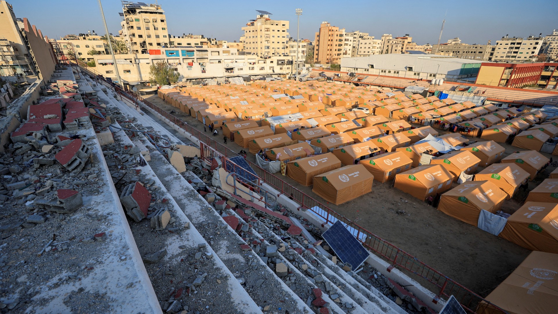 Displaced Palestinians take shelter in a tent camp set up at Palestine Stadium, which was damaged during the Israeli offensive, in Gaza City, March 11, 2025. REUTERS/Dawoud Abu Alkas 