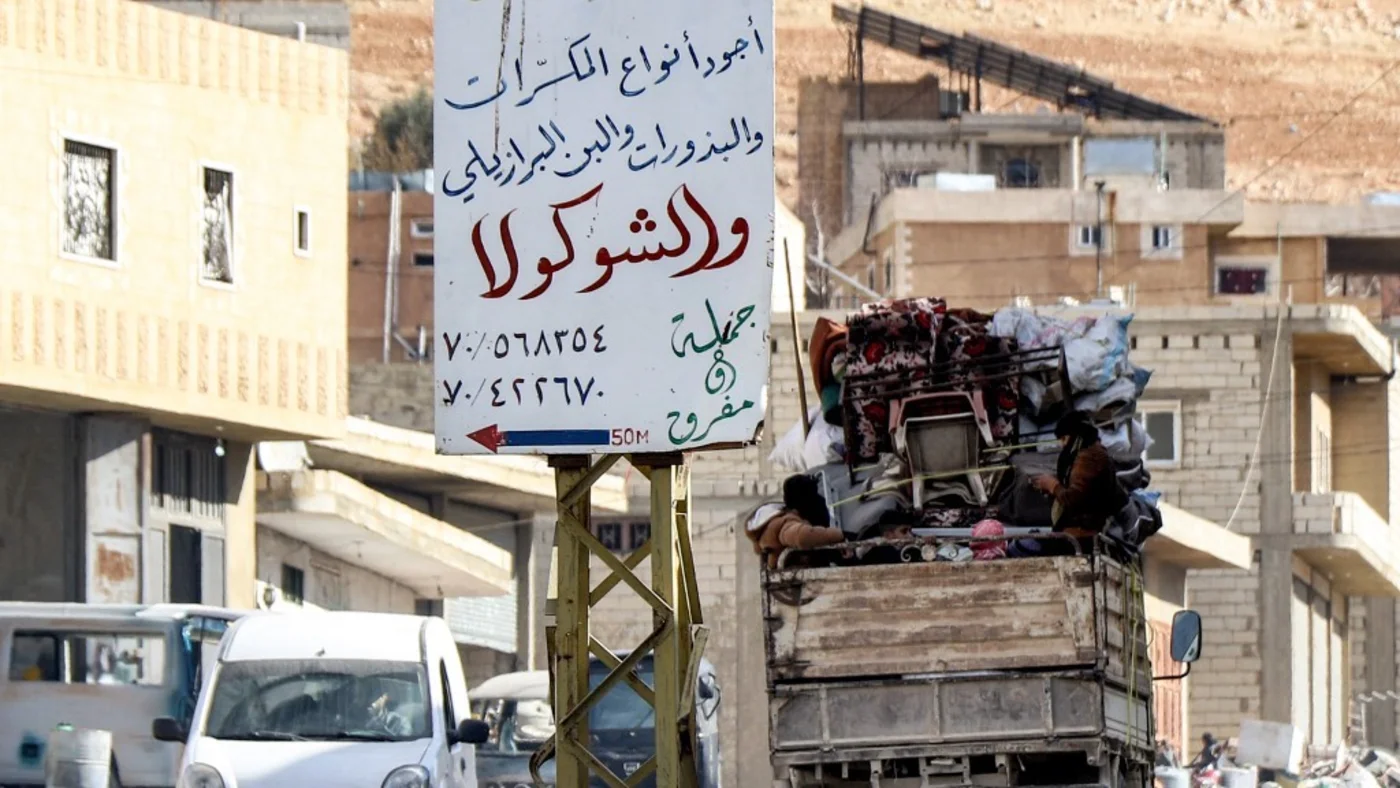 Syrian refugees drive from a camp in Arsal in eastern Lebanon