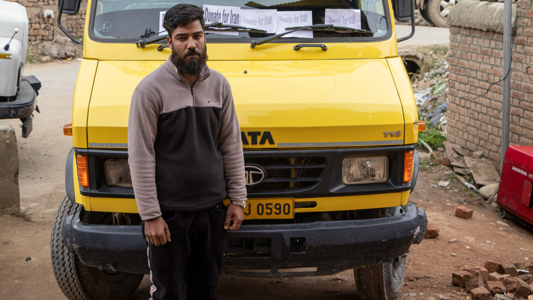 Sadakat Ali Mir, 23, donates his mini truck toward humanitarian efforts in Iran (Umar Farooq/MEE)