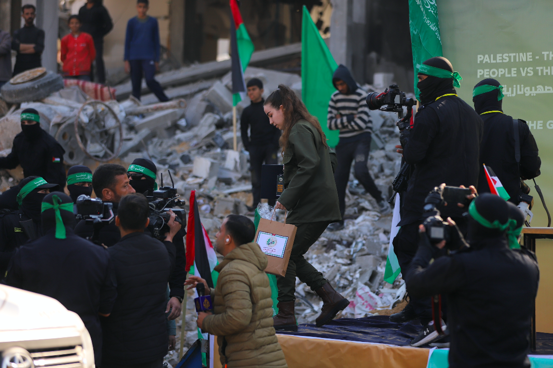 Released Israeli captive Agam Berger leaves stage before Hamas handed her over to a Red Cross team in Jabalia on January 30, 2025. (Mohamed al-Hajjar)