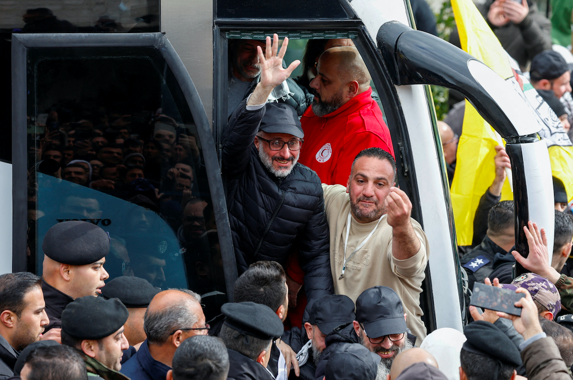 A freed Palestinian prisoner waves in Ramallah after being released from an Israeli jail as part of a ceasefire deal in Gaza. (Reuters/Mohammed Torokman)