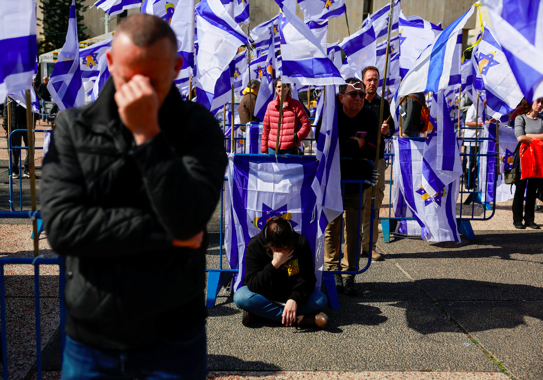 People react on the day the bodies of four Israeli captives are handed over under the terms of a ceasefire between Hamas and Israel, in Tel Aviv, Israel February 20, 2025. (REUTERS/Ammar Awad)