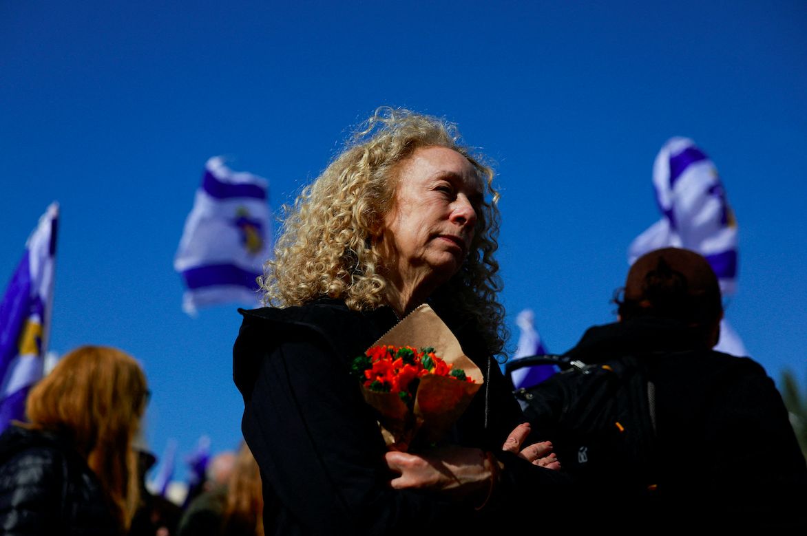 A woman reacts on the day the bodies of four Israeli captives are handed over under the terms of a ceasefire between Hamas and Israel, in Tel Aviv, Israel February 20, 2025. (REUTERS/Ammar Awad)