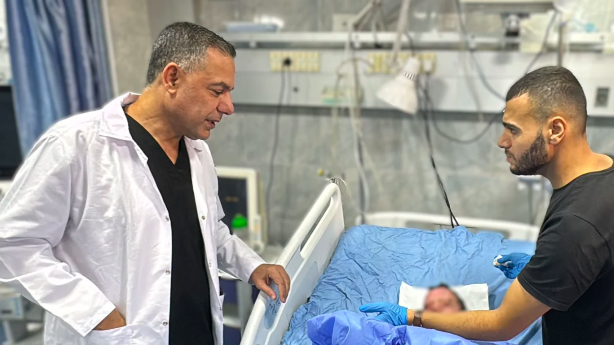 Hussam Abu Safiya, the director of Kamal Adwan Hospital in Beit Lahia, checks on an injured child on 24 October in north Gaza. (AFP)