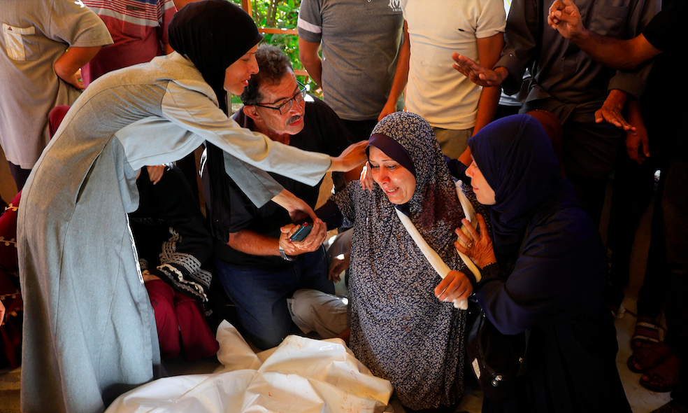 Mourners react near the bodies of Palestinians killed, in what the Gaza Health Ministry said, were overnight Israeli airstrikes on tents sheltering displaced people, at Nasser hospital, in Khan Younis, southern Gaza Strip, June 26, 2025. 