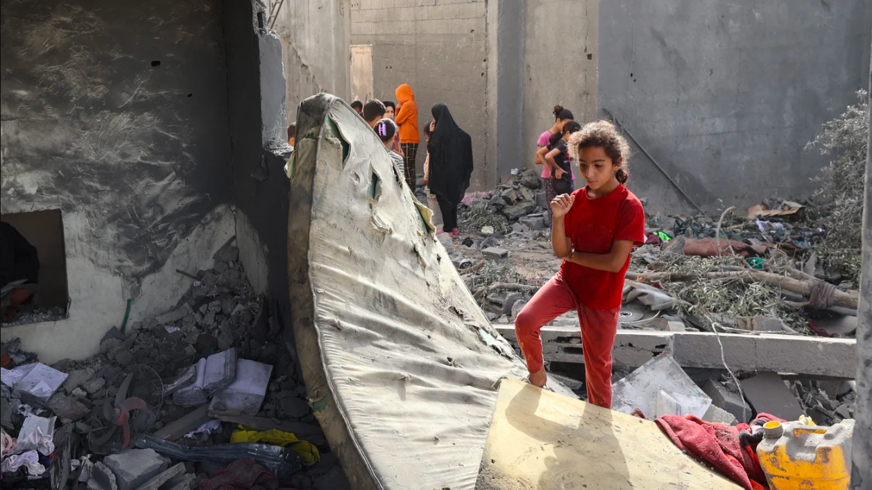 Palestinian children check the rubble of a residential house in Deir el-Balah in the central Gaza Strip on 1 July 2025, following overnight Israeli strikes (AFP/Eyad Baba)