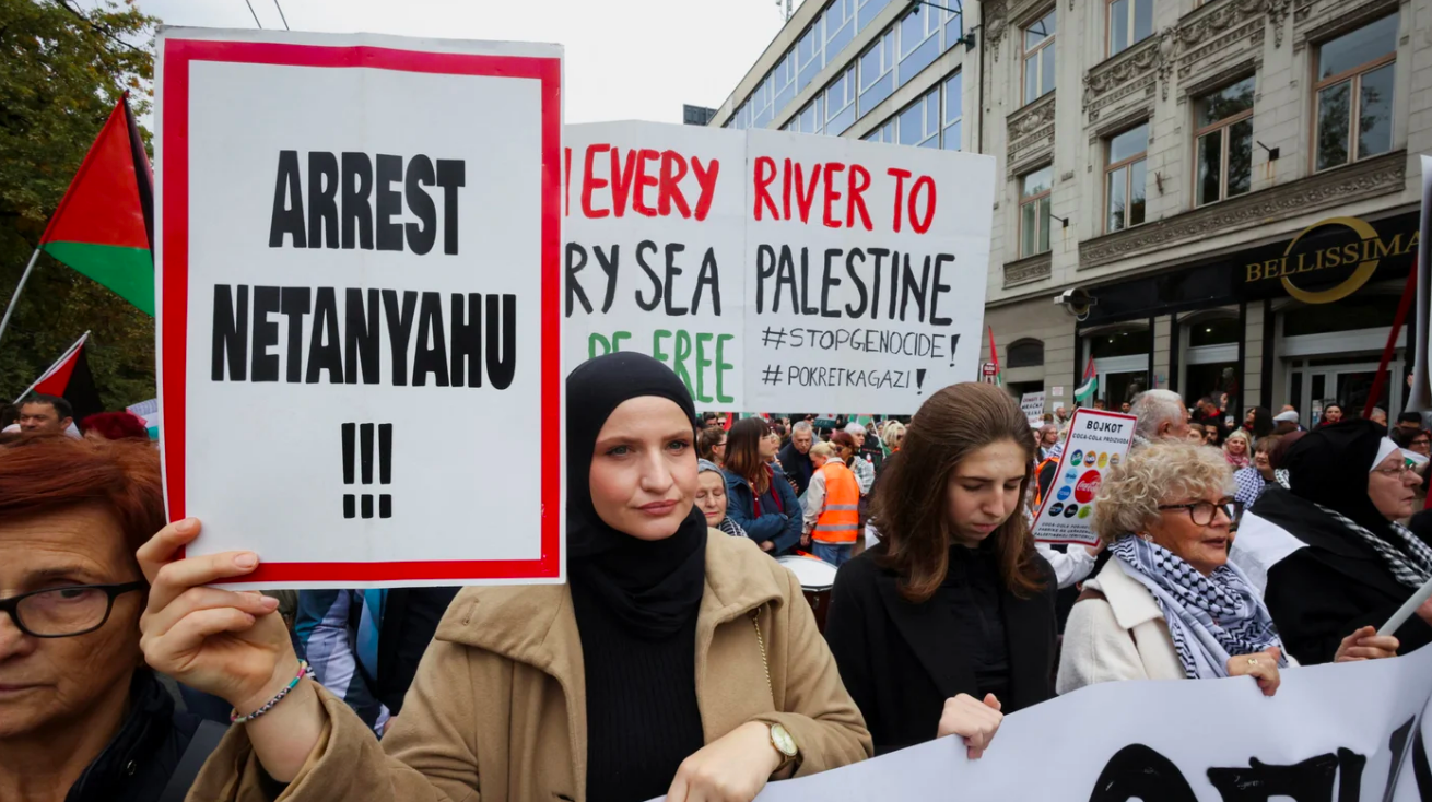 Protesters hold signs calling for the arrest of Israeli Prime Minister Benjamin Netanyahu during a Palestine solidarity protest in Sarajevo, Bosnia and Herzegovina, on 12 October 2025 (Amel Emric/Reuters)