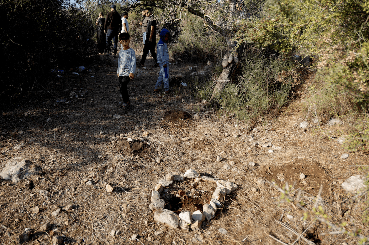 People inspect around the site where Israeli forces killed three Palestinians, near Jenin, in the Israeli occupied West Bank October 28, 2025. REUTERS/Raneen Sawafta