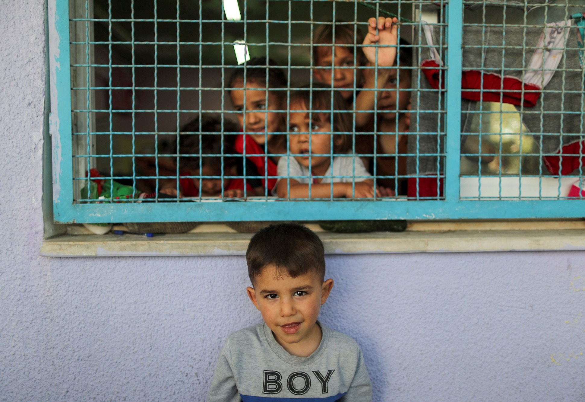 A young boy is photographed seeking shelter in a UNRWA school (Reuters)