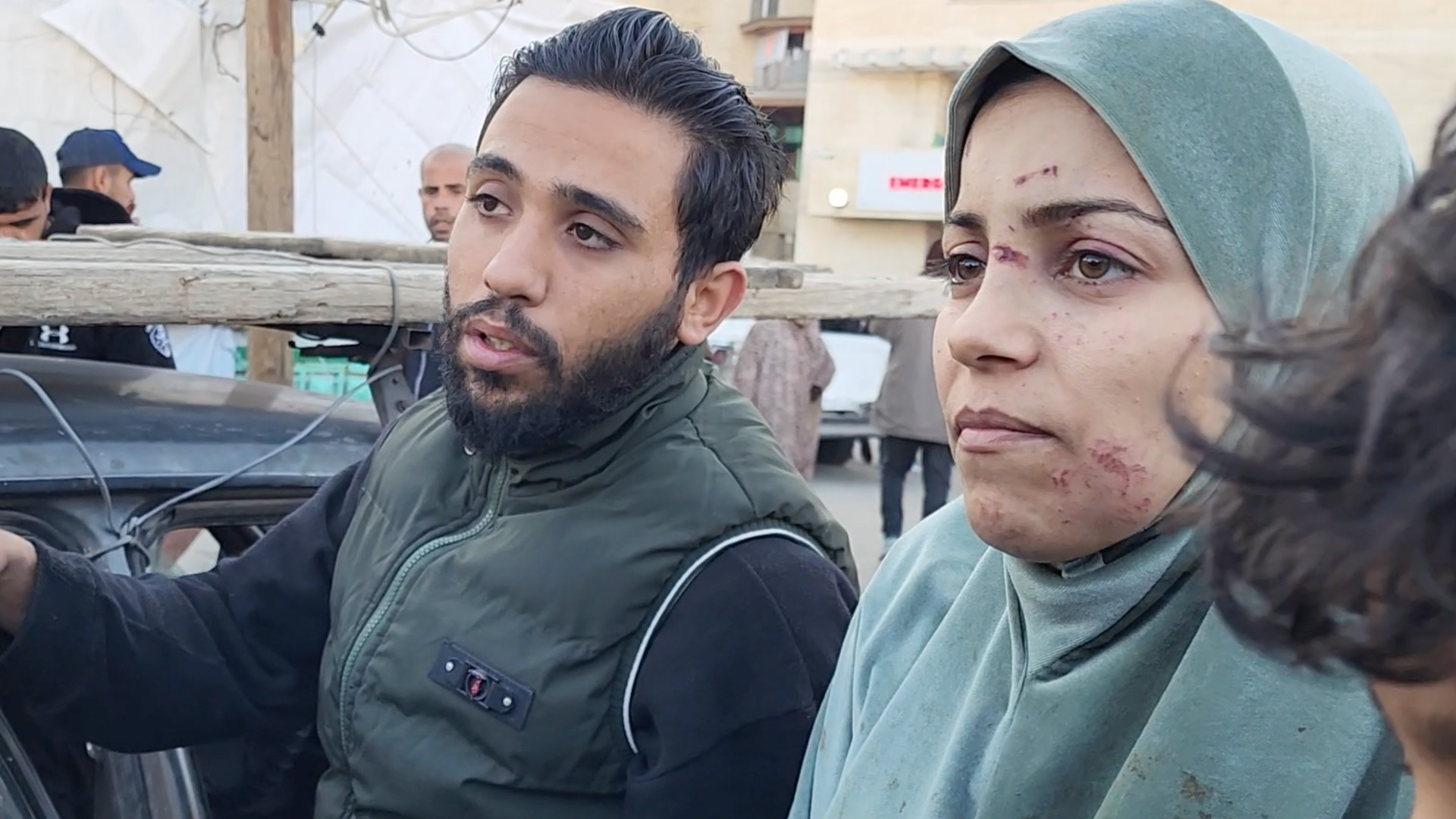 Malak Abu Sharara (R) preparing the body her son Mohammed for burial at al-Aqsa Martyrs Hospital in Deir al-Balah (Osama Kahlout/MEE)