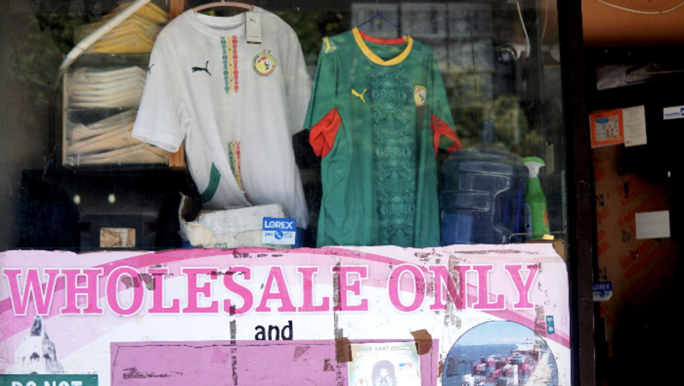 Senegalese football shirts hang from stores in Harlem (MEE/Azad Essa)