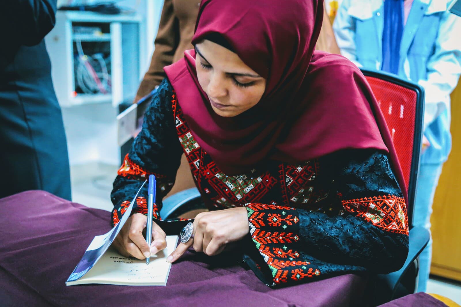 Shurooq Doghmosh signing copies of her debut novel, 'I Was Killed At Around This time' (Facebook)