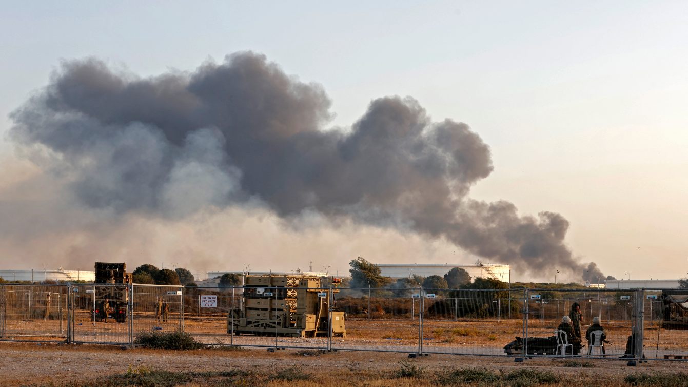 Smoke billows from Trans-Israel pipeline oil facility in Ashkelon as rockets are fired from Gaza towards Israel, 11 May 2021 (Jack Guez/AFP)