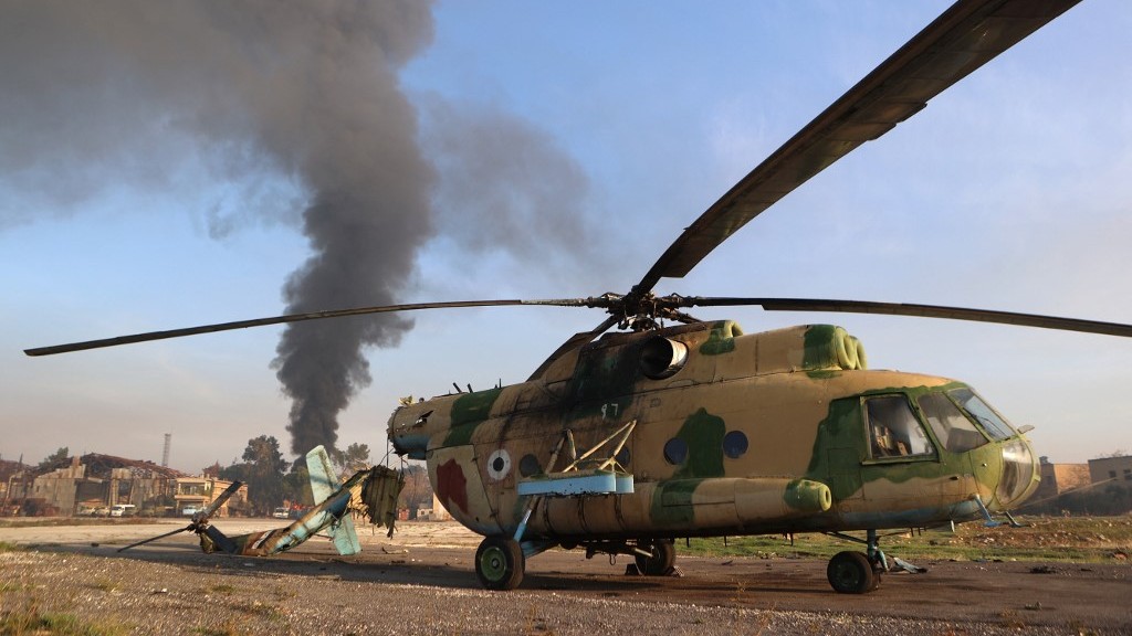 A destroyed Syrian army helicopter at the Nayrab military airport near Aleppo after rebels seized most of the city, its airport and nearby towns on 30 November (Aaref Watad/AFP)