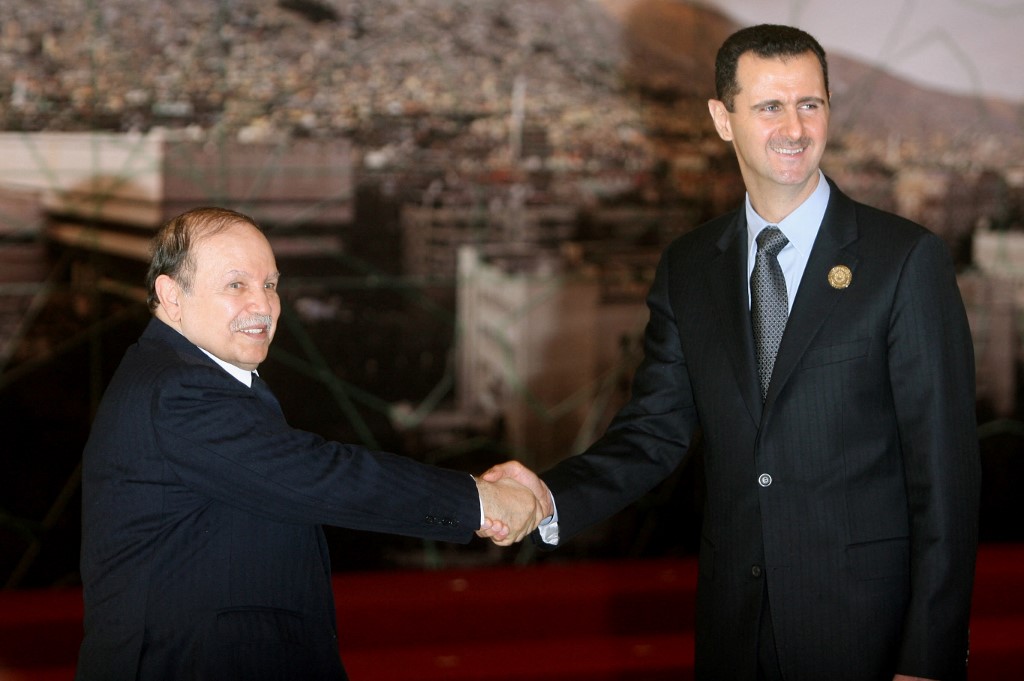 Syrian President Bashar al-Assad (R) shakes hands with his Algerian counterpart Abdelaziz Bouteflika at the time at the opening session of the Arab Summit in Damascus in March 2008 (Awad Awad/AFP)