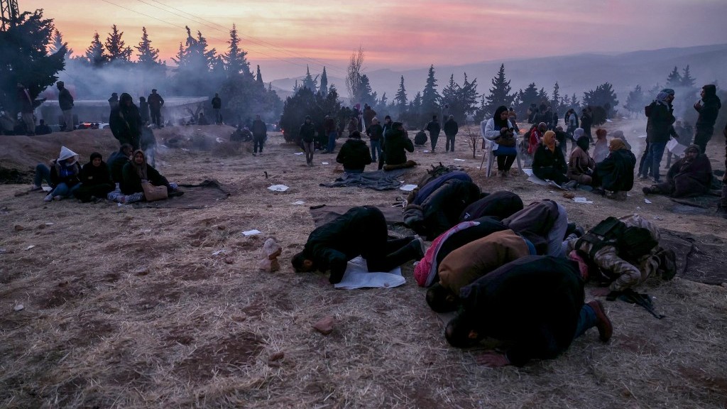 People pray as they gather at Sednaya Prison in Damascus looking for their relatives on 9 December 2024 (Omar Haj Kadour/AFP) 