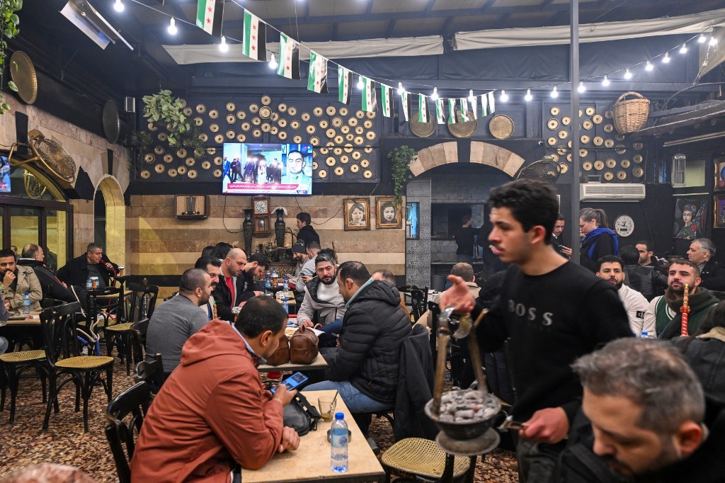 People sit in the Rawda caffe in the centre of the Syrian capital Damascus on January 29, 2025. LOUAI BESHARA / AFP